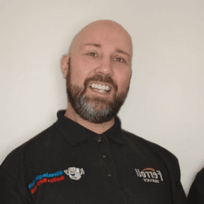 Dave, smiling, in his work polo shirt